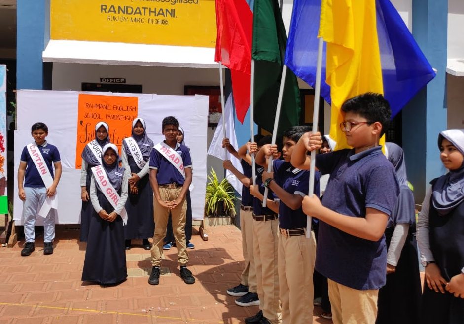 Student leaders with flags and sashes at the investiture ceremony