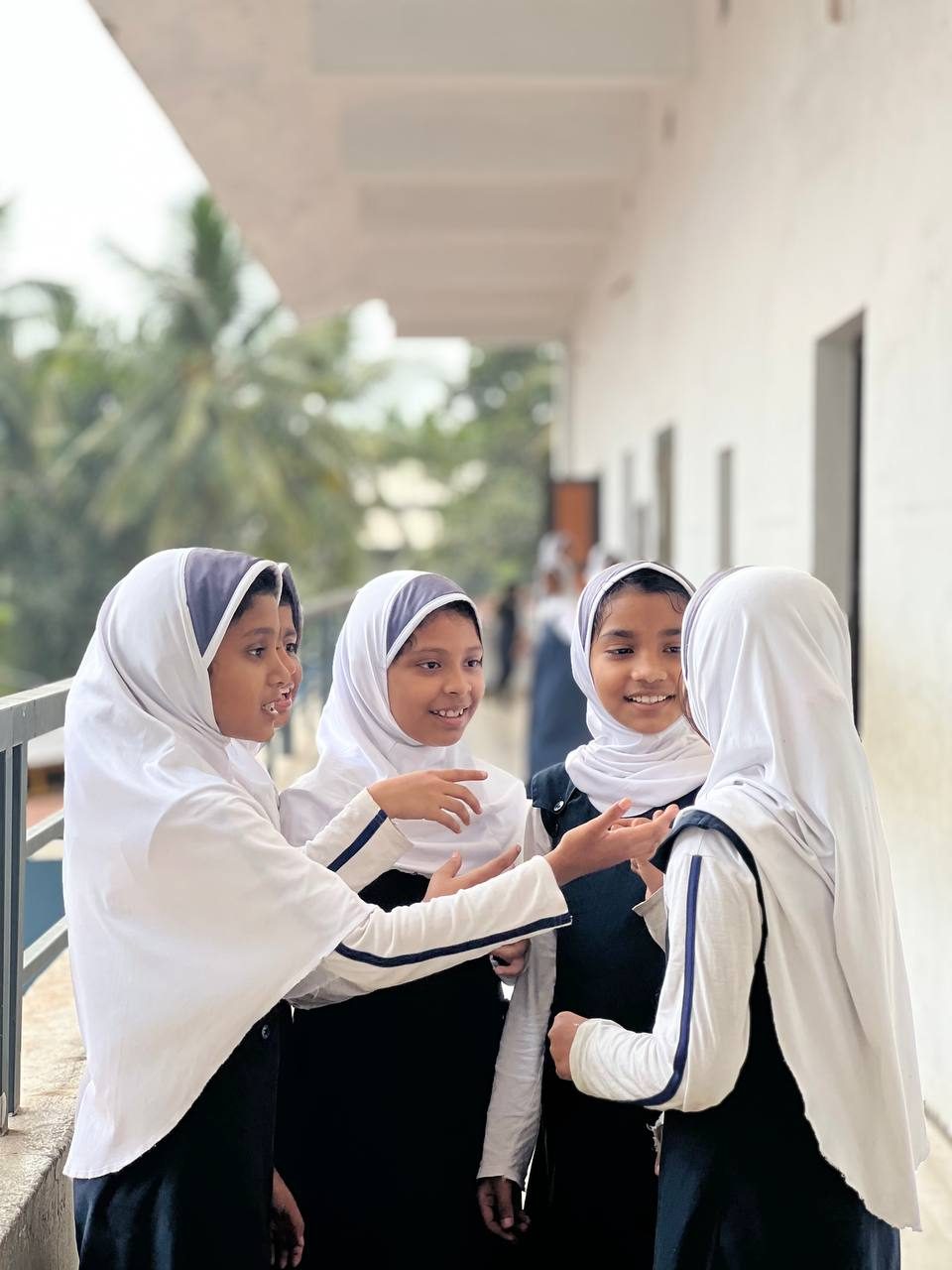 Students from Y's International School chatting on the school veranda