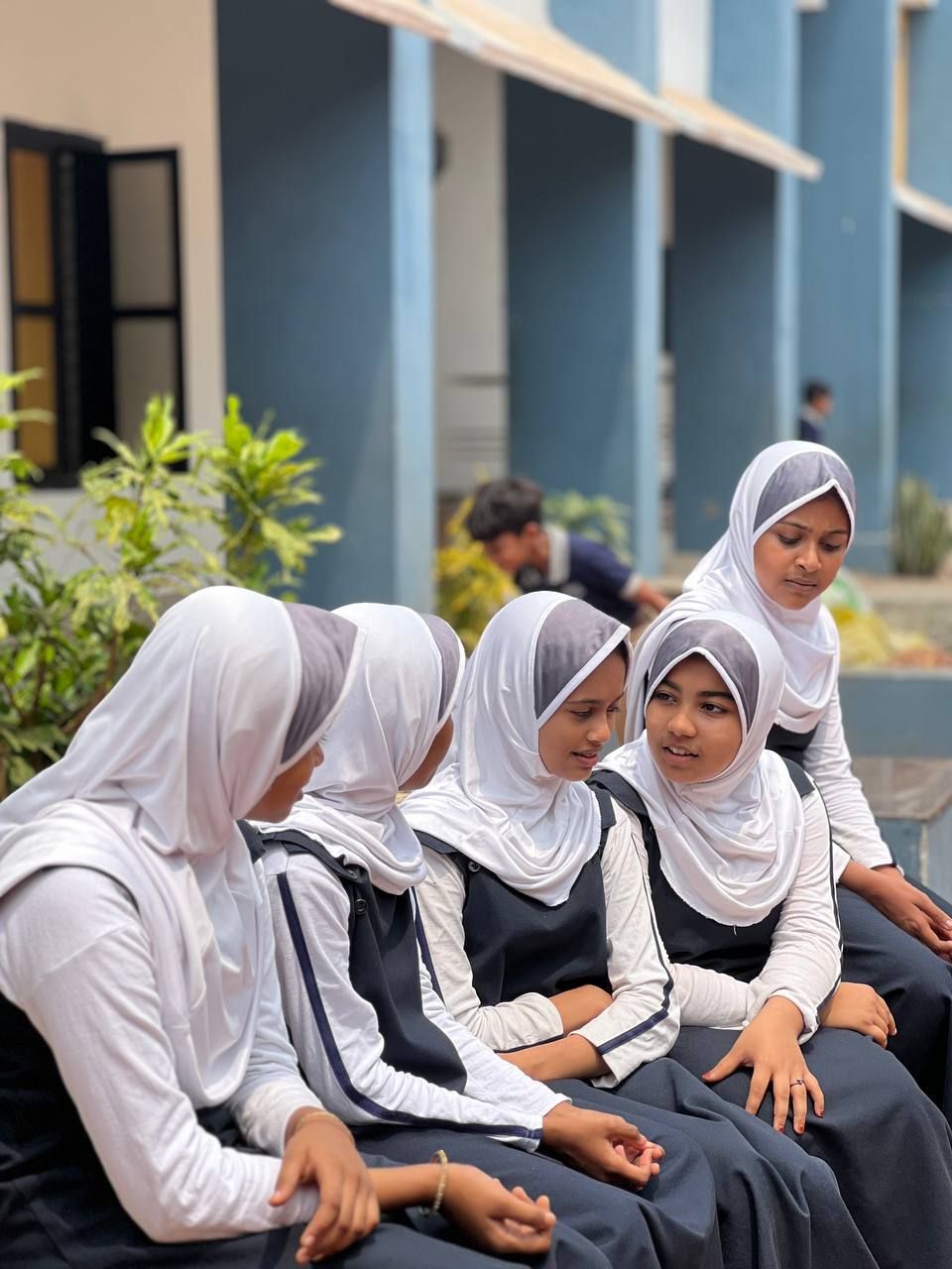 Students sitting together outside school
