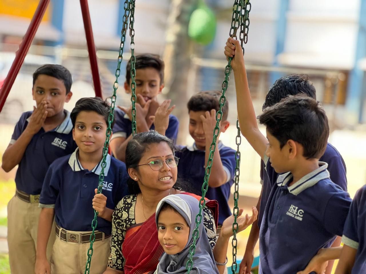 Students playing on the swings